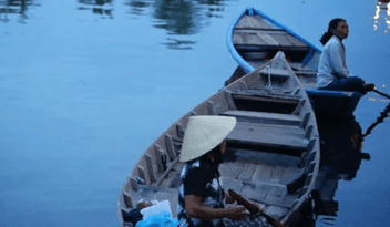 Two Asian woman on boats 